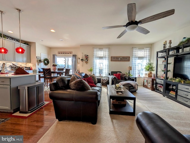 living room with ceiling fan and light wood-type flooring