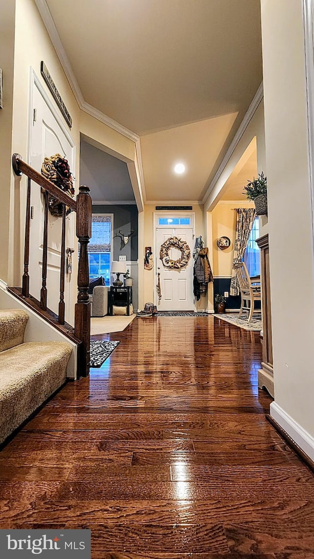 entrance foyer with hardwood / wood-style floors and crown molding