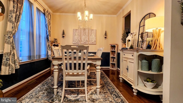 dining room with crown molding, dark hardwood / wood-style floors, and a chandelier