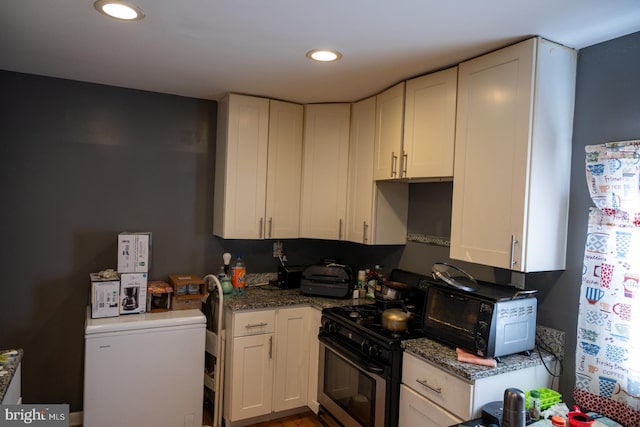 kitchen with gas stove, recessed lighting, stone countertops, and white cabinets