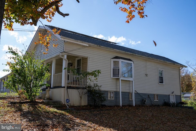 view of side of property with covered porch