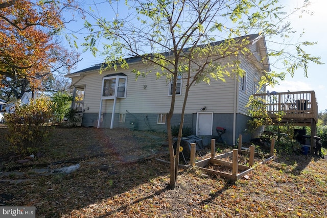 back of property featuring a wooden deck