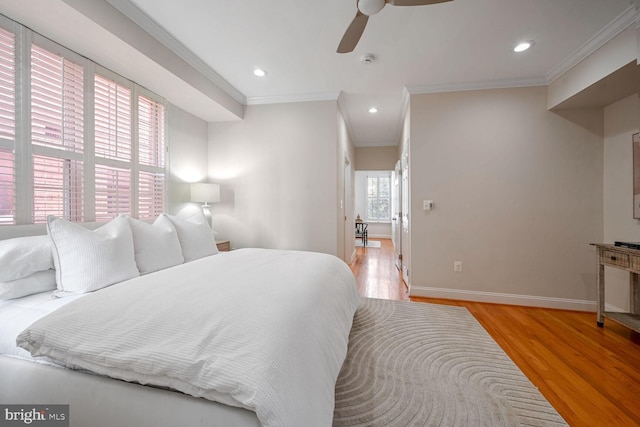 bedroom featuring ornamental molding, light hardwood / wood-style flooring, and ceiling fan