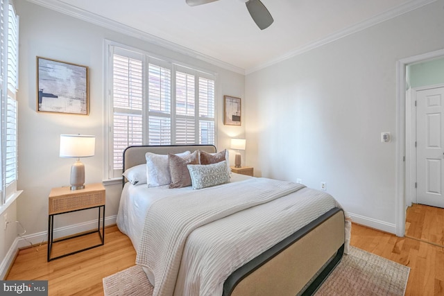 bedroom with light hardwood / wood-style flooring, ceiling fan, and crown molding