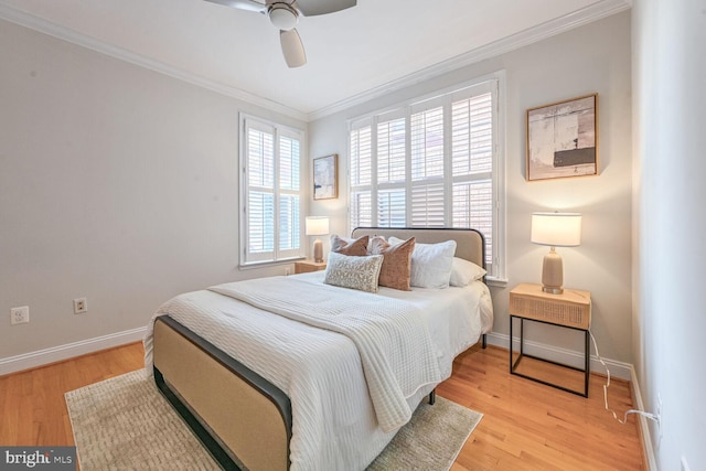 bedroom with light hardwood / wood-style floors, ceiling fan, and crown molding