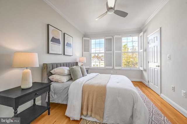 bedroom with ornamental molding, light wood-type flooring, and ceiling fan