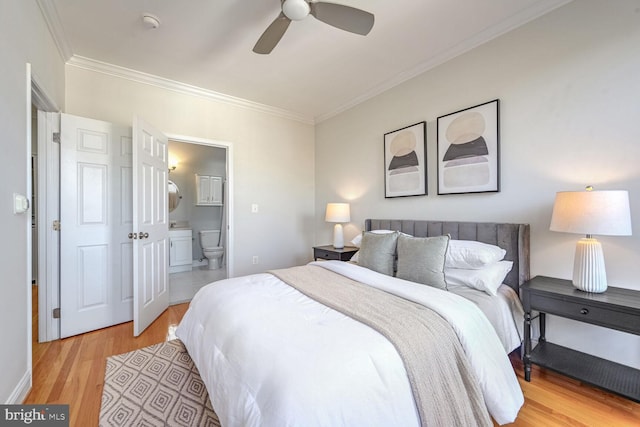 bedroom featuring ensuite bathroom, light hardwood / wood-style flooring, ceiling fan, and crown molding