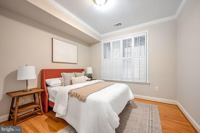 bedroom featuring wood-type flooring and ornamental molding