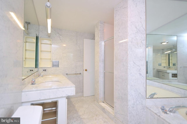 full bathroom with a garden tub, a shower stall, tile walls, and vanity