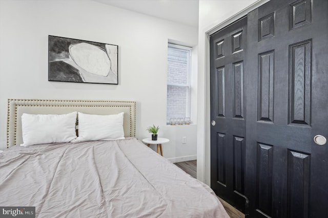 bedroom with hardwood / wood-style flooring