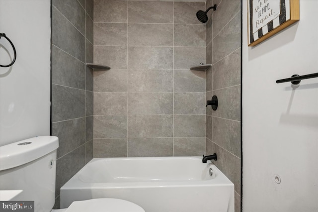 bathroom featuring tiled shower / bath and toilet