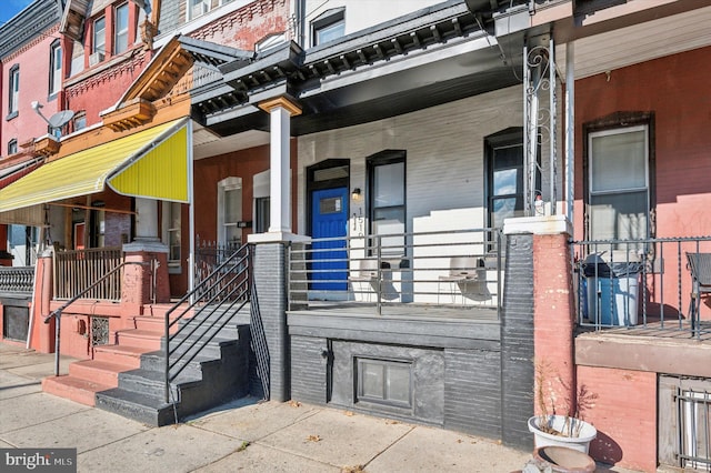 view of exterior entry with a porch