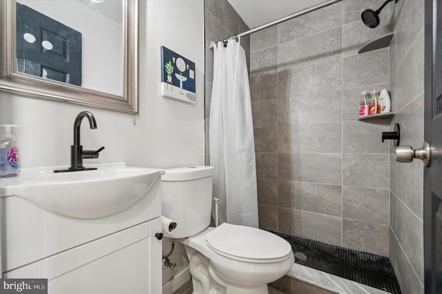 bathroom featuring curtained shower, vanity, and toilet