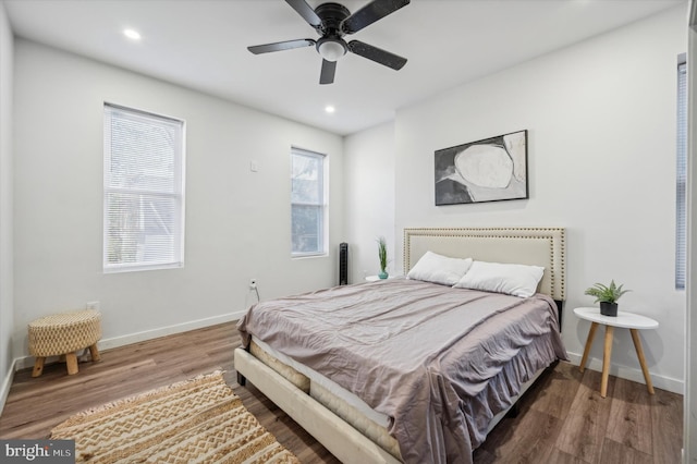 bedroom featuring wood finished floors, recessed lighting, baseboards, and ceiling fan
