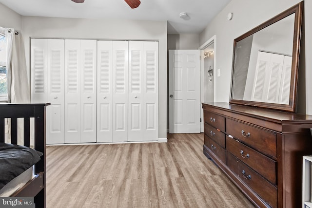 bedroom with light hardwood / wood-style flooring, ceiling fan, and a closet