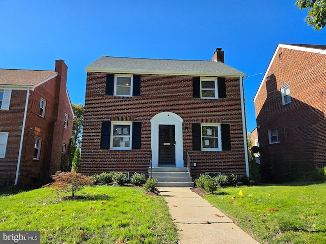 colonial home with a front lawn