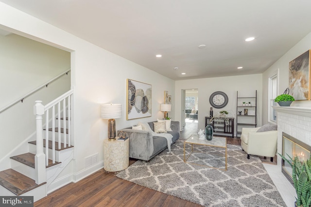 living room featuring a fireplace and wood-type flooring