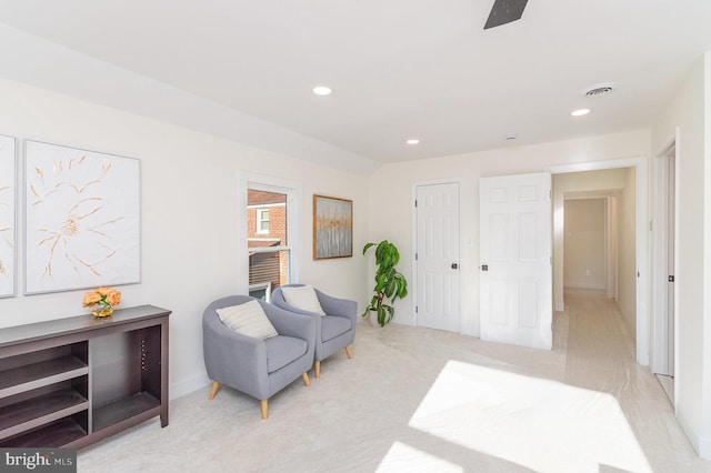 living area with light carpet