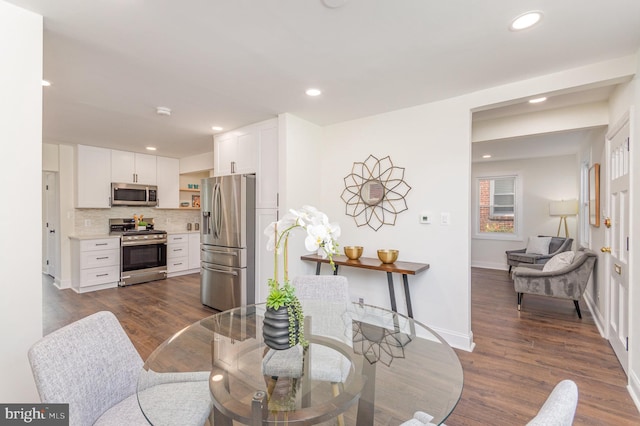 dining room with dark hardwood / wood-style flooring