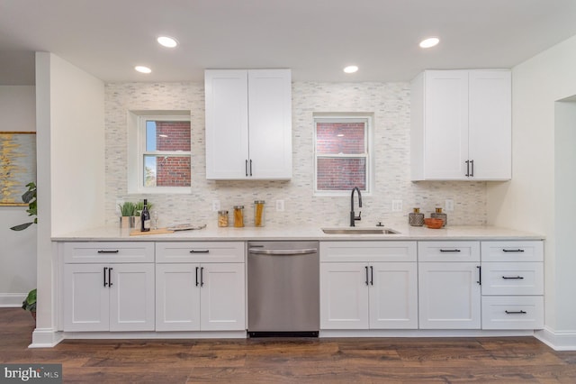 kitchen featuring stainless steel dishwasher, white cabinets, sink, and dark wood-type flooring