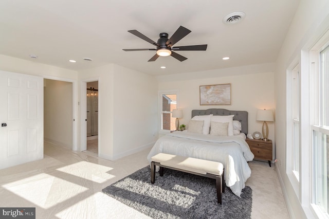 bedroom with ceiling fan and light colored carpet