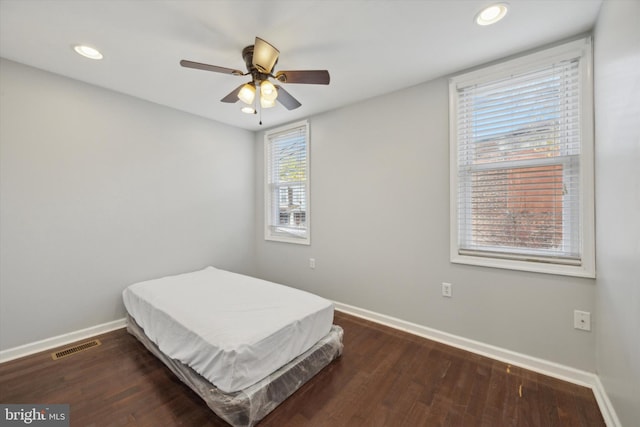 bedroom featuring ceiling fan and dark wood-type flooring