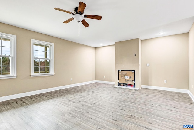 unfurnished living room with ceiling fan and light wood-type flooring