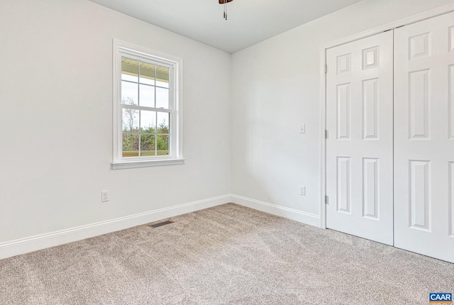 empty room featuring carpet flooring and ceiling fan