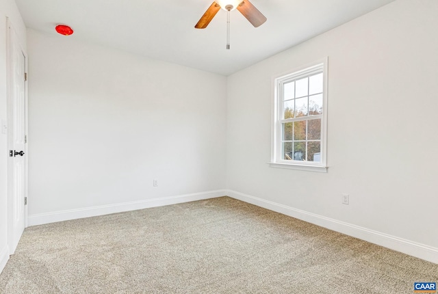 empty room with ceiling fan and carpet floors