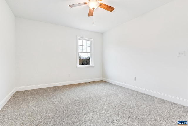 carpeted empty room featuring ceiling fan