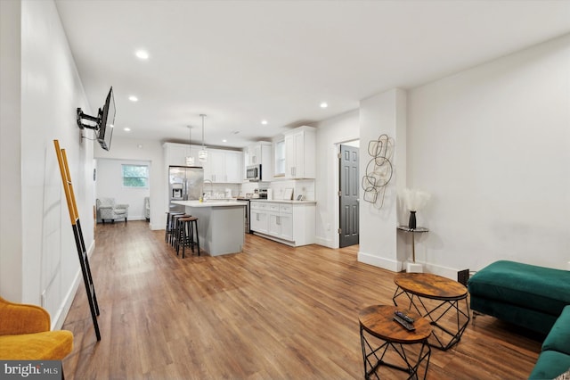 606 N 43rd St, Philadelphia, PA 19104 - living room with recessed lighting, light wood-style flooring, and baseboards