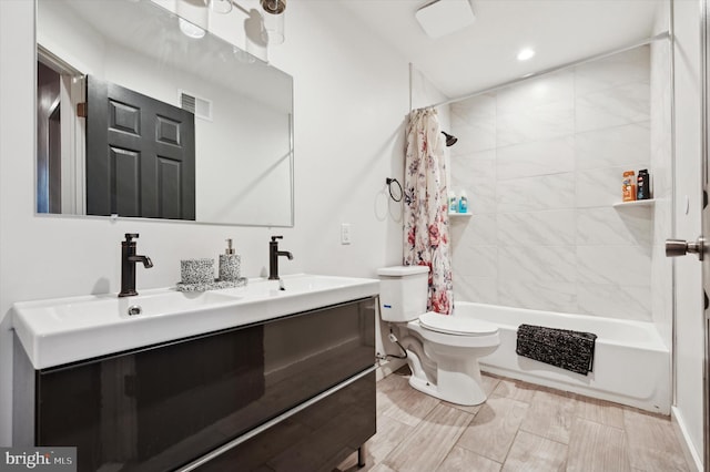 full bathroom featuring shower / bath combination with curtain, toilet, and vanity