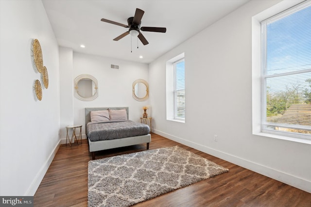 living area with hardwood / wood-style floors and ceiling fan