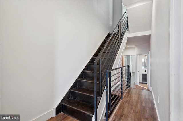 stairway featuring wood-type flooring