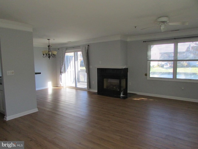 unfurnished living room featuring ornamental molding, ceiling fan with notable chandelier, and dark hardwood / wood-style flooring