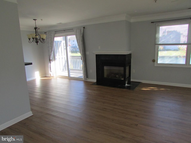 unfurnished living room with ornamental molding, a chandelier, and dark hardwood / wood-style floors