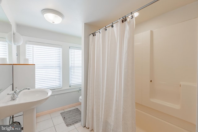 full bathroom with toilet, sink, tile patterned floors, and shower / bathtub combination with curtain