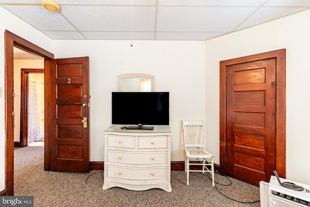 carpeted bedroom featuring a drop ceiling