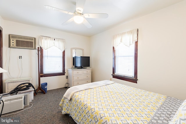 carpeted bedroom featuring ceiling fan, multiple windows, and an AC wall unit