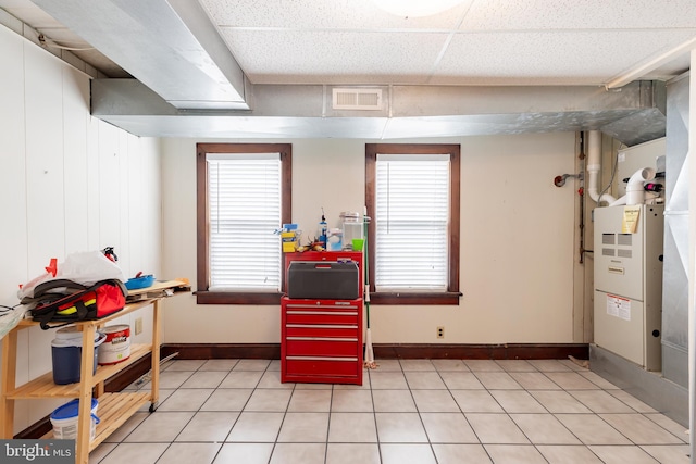 rec room featuring light tile patterned flooring and heating unit