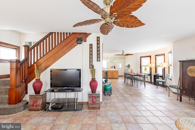 tiled living room featuring ceiling fan