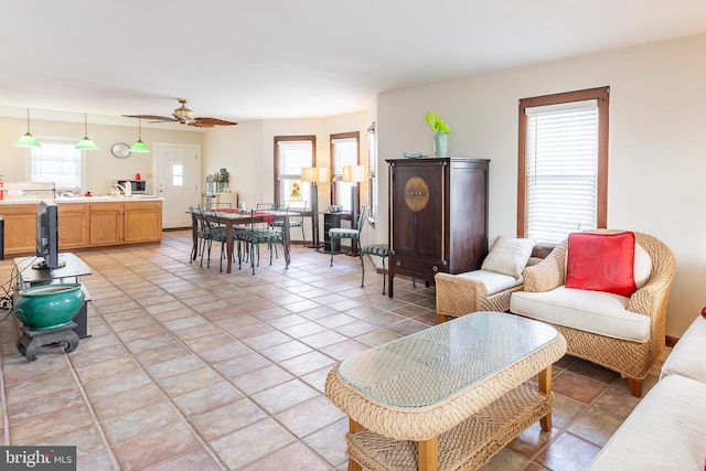 tiled living room featuring ceiling fan