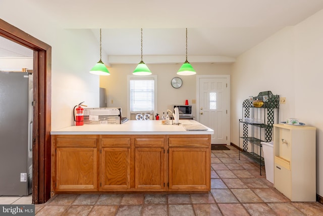 kitchen featuring hanging light fixtures and appliances with stainless steel finishes