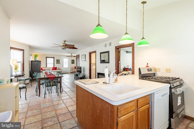 kitchen with dishwasher, sink, gas stove, ceiling fan, and pendant lighting