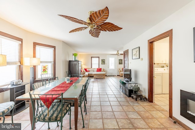 dining room featuring independent washer and dryer and ceiling fan