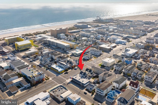 bird's eye view featuring a view of the beach and a water view