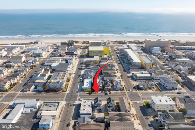 bird's eye view featuring a water view and a beach view