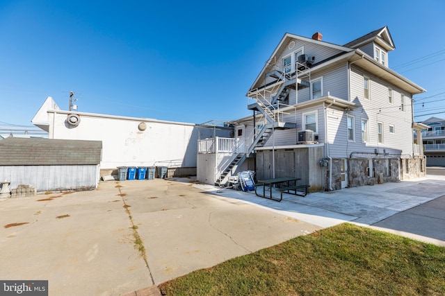 view of property exterior featuring cooling unit and a patio area