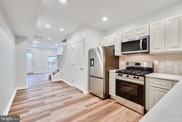 1341 Sargeant St, Baltimore, MD 21223 - kitchen with stainless steel appliances, light wood-style floors, tasteful backsplash, baseboards, and recessed lighting
