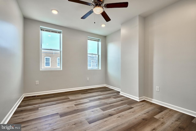 empty room featuring hardwood / wood-style flooring and ceiling fan